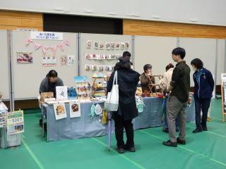 バザーブースの写真。雑貨が並び来場者が興味深そうに見ている。